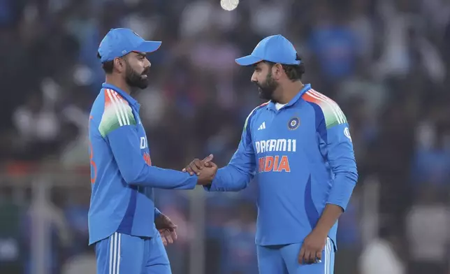 India's captain Rohit Sharma, right, and Virat Kohli celebrate after winning the third one day international cricket match and series against England in Ahmedabad, India, Wednesday, Feb. 12, 2025. (AP Photo/ Ajit Solanki )
