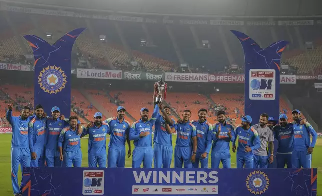 Indian players posses with the trophy after winning one day international cricket series against England in Ahmedabad, India, Wednesday, Feb. 12, 2025. (AP Photo/ Ajit Solanki )