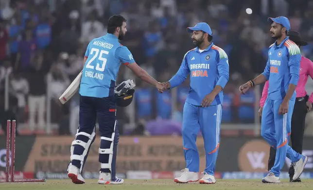 India's captain Rohit Sharma, second from right, shakes hand with England's Saqib Mahmood, left, after winning the third one day international cricket match and series against England in Ahmedabad, India, Wednesday, Feb. 12, 2025. (AP Photo/ Ajit Solanki )