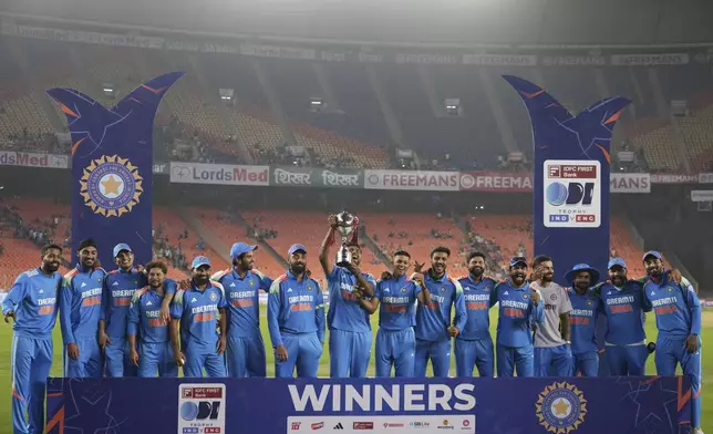 Indian players posses with the trophy after winning one day international cricket series against England in Ahmedabad, India, Wednesday, Feb. 12, 2025. (AP Photo/ Ajit Solanki )