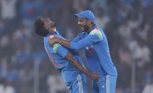 India's Harshit Rana, left, and Axar Patel, right, celebrates the wicket of England's Harry Brook during the third one day international cricket match between India and England in Ahmedabad, India, Wednesday, Feb. 12, 2025. (AP Photo/ Ajit Solanki )
