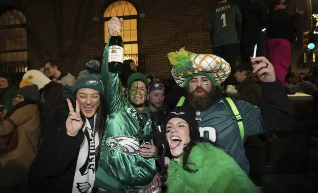 Fans celebrate the Eagles' win in the NFL Super Bowl LIX, on Broad Street, Sunday, Feb. 9, 2025, in Philadelphia. (Jessica Griffin/The Philadelphia Inquirer via AP)