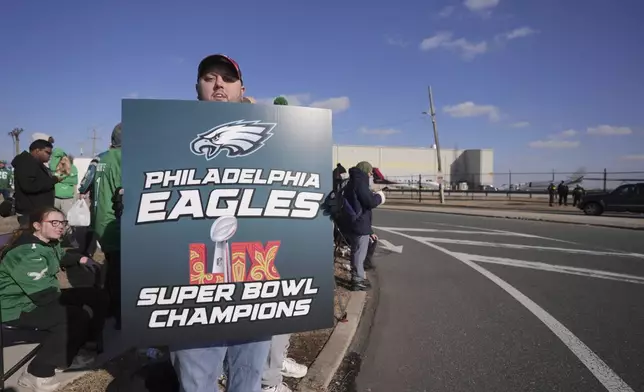 Philadelphia Eagles fans wait for the arrival of their team at Philadelphia International Airport, Monday, Feb. 10, 2025. (AP Photo/Chris Szagola)