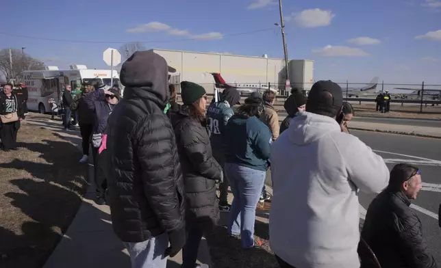 Philadelphia Eagles fans wait for the arrival of their team at Philadelphia International Airport, Monday, Feb. 10, 2025. (AP Photo/Chris Szagola)