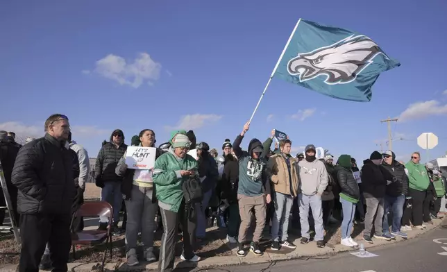 Philadelphia Eagles fans wait for the arrival of their team at Philadelphia International Airport, Monday, Feb. 10, 2025. (AP Photo/Chris Szagola)