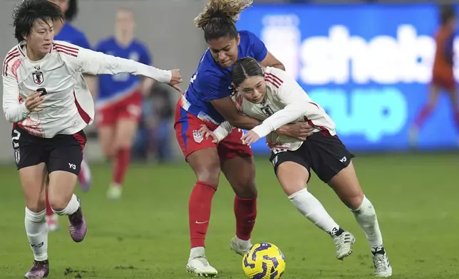 Japan midfielder Fuka Nagano, right, battles United States forward Catarina Macario for a ball during the first half of a SheBelieves Cup women's soccer tournament match Wednesday, Feb. 26, 2025, in San Diego. (AP Photo/Gregory Bull)
