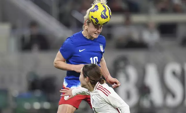 United States midfielder Lindsey Heaps heads the ball on goal as Japan defender Hikaru Kitagawa defends during the first half of a SheBelieves Cup women's soccer tournament match Wednesday, Feb. 26, 2025, in San Diego. (AP Photo/Gregory Bull)