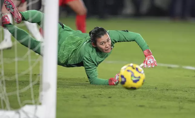 Japan goalkeeper Ayaka Yamashita watches as a shot from United States forward Catarina Macario just misses during the first half of a SheBelieves Cup women's soccer tournament match Wednesday, Feb. 26, 2025, in San Diego. (AP Photo/Gregory Bull)