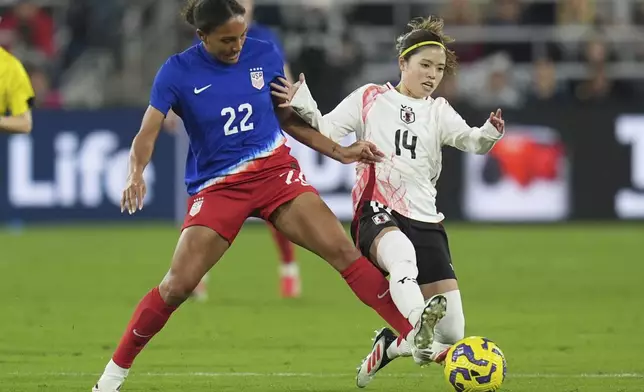 Japan midfielder Yui Hasegawa (14) battles United States forward Yazmeen Ryan for the ball during the first half of a SheBelieves Cup women's soccer tournament match Wednesday, Feb. 26, 2025, in San Diego. (AP Photo/Gregory Bull)