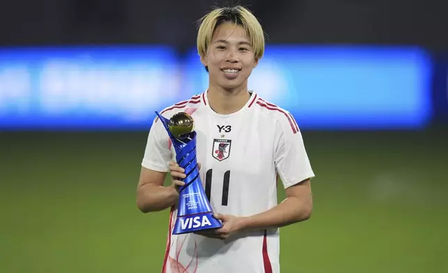 Japan forward Mina Tanaka poses with the Most Valuable Player trophy after Japan defeated the United States to win the SheBelieves Cup women's soccer tournament Wednesday, Feb. 26, 2025, in San Diego. (AP Photo/Gregory Bull)