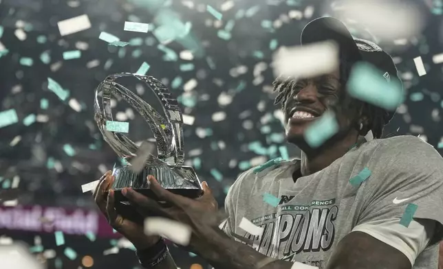 Philadelphia Eagles wide receiver A.J. Brown holds the championship trophy after the Eagles won the NFC Championship NFL football game against the Washington Commanders, Sunday, Jan. 26, 2025, in Philadelphia. (AP Photo/Matt Slocum)