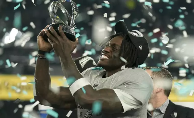 Philadelphia Eagles wide receiver A.J. Brown celebrates with the trophy after their win against the Washington Commanders in the NFC Championship NFL football game, Sunday, Jan. 26, 2025, in Philadelphia. (AP Photo/Seth Wenig)