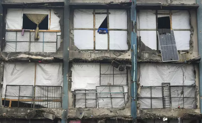 Nylon covers holes in the destroyed walls of the Jabaliya Girls Preparatory School which displaced people are using as shelter in the Jabaliya refugee camp in the northern Gaza Strip, Monday, Feb. 10, 2025. (AP Photo/Abdel Kareem Hana)