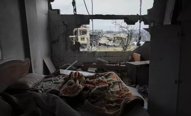 Destruction outside is seen from a damaged bedroom of the Nassar family home in the Jabaliya refugee camp in the northern Gaza Strip, Sunday, Feb. 9, 2025. (AP Photo/Abdel Kareem Hana)