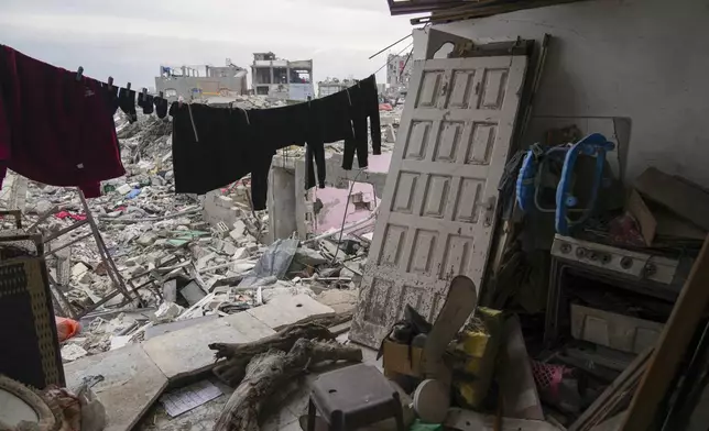 Clothes hang to dry outside a destroyed room belonging to the Nassar family in the Jabaliya refugee camp in the northern Gaza Strip, Sunday, Feb. 9, 2025. (AP Photo/Abdel Kareem Hana)