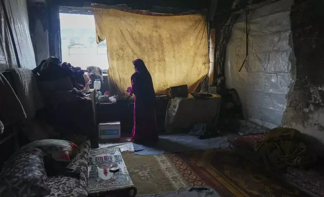 Hanan Okal, 22, prepares breakfast for her children inside a classroom in the Jabaliya Girls Preparatory School, which displaced people use as a shelter, in the Jabaliya refugee camp in the northern Gaza Strip, Monday, Feb. 10, 2025. (AP Photo/Abdel Kareem Hana)