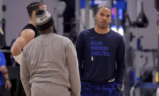 Dallas Mavericks general manager Nico Harrison, right, talks with team staff at the end of an NBA basketball practice at the team's training facility in Dallas, Thursday, Feb. 20, 2025. (AP Photo/Tony Gutierrez)