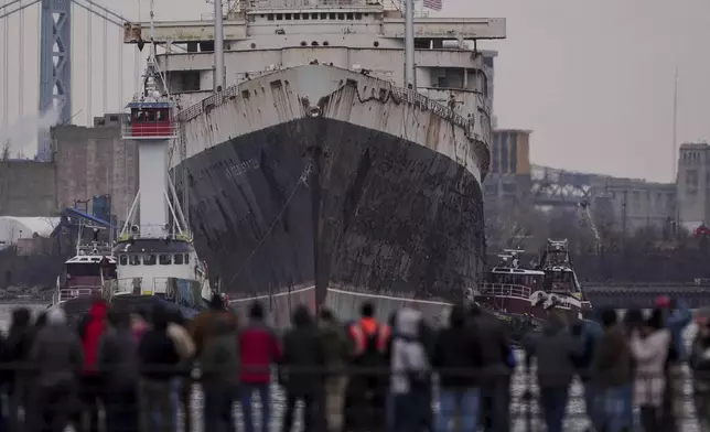 The SS United States is towed down the Delaware River between Pennsylvania and New Jersey, from Philadelphia, Wednesday, Feb. 19, 2025. (AP Photo/Matt Rourke)
