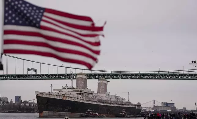 The SS United States is towed down the Delaware River between Pennsylvania and New Jersey, from Philadelphia, Wednesday, Feb. 19, 2025. (AP Photo/Matt Rourke)