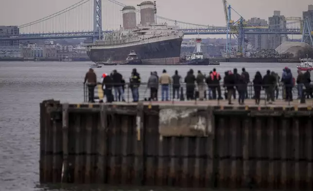 The SS United States is towed down the Delaware River between Pennsylvania and New Jersey, from Philadelphia, Wednesday, Feb. 19, 2025. (AP Photo/Matt Rourke)