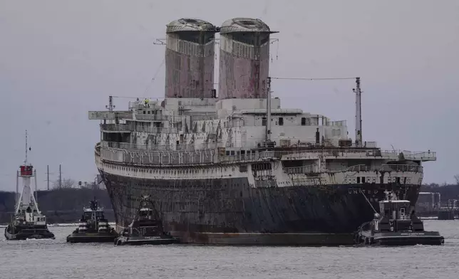 The SS United States is towed down the Delaware River between Pennsylvania and New Jersey, from Philadelphia, Wednesday, Feb. 19, 2025. (AP Photo/Matt Rourke)