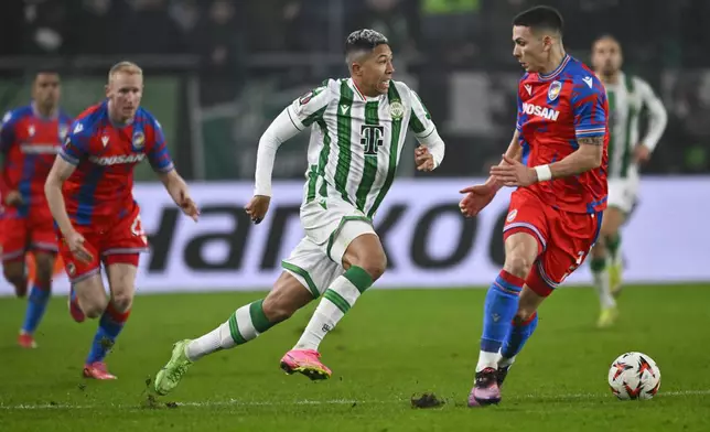 Ferencvaros' Matheus Saldanha challenges for the ball with Plzen's Svetozar Markovic during a Europa League playoff first leg soccer match between Ferencvaros and Viktoria Plzen at the Groupama Arena stadium, in Budapest, Hungary, Thursday, Feb. 13, 2025. (AP Photo/Denes Erdos)