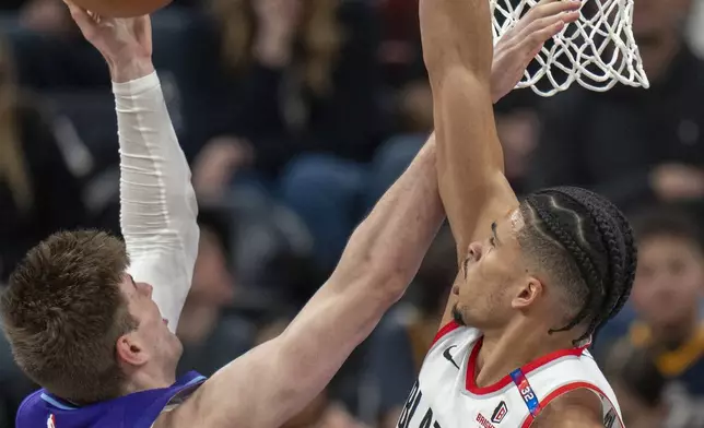 Utah Jazz forward Kyle Filipowski (22) shoots as Portland Trail Blazers forward Toumani Camara (33) defends during the second half of an NBA basketball game Monday, Feb. 24, 2025, in Salt Lake City. (AP Photo/Rick Egan)