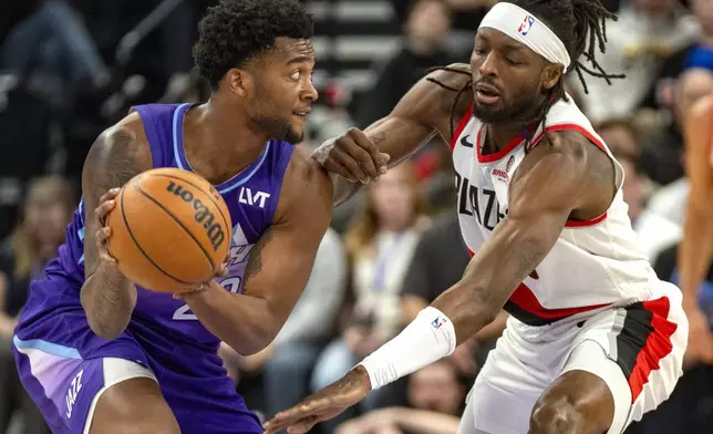 Utah Jazz forward Brice Sensabaugh, left, looks downcourt as Portland Trail Blazers forward Jerami Grant, right, defends during the first half of an NBA basketball game Monday, Feb. 24, 2025, in Salt Lake City. (AP Photo/Rick Egan)