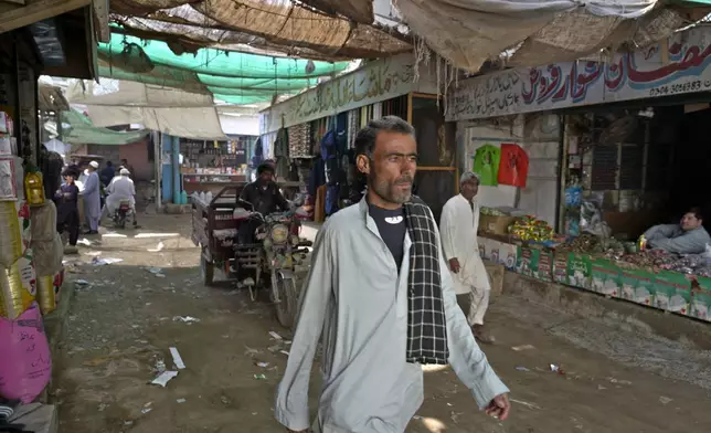 People walk through a market in the coastal city of Gwadar, in the southwest Pakistani province of Balochistan, Jan. 13, 2025. (AP Photo/Anjum Naveed)