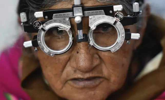 Livedina China undergoes an eye exam during a municipal campaign to distribute free glasses to senior citizens in El Alto, Bolivia, Wednesday, Feb. 5, 2025. (AP Photo/Juan Karita)