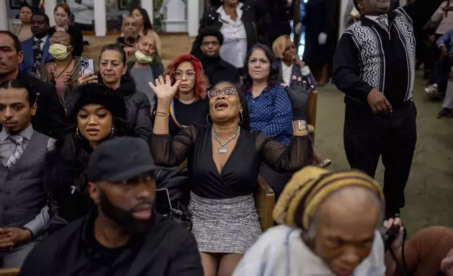 People attend a memorial service for fire victims at the First AME Church, Thursday, Feb. 6, 2025, in Pasadena, Calif. (AP Photo/Ethan Swope)