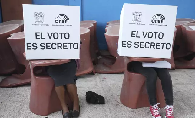 Voters mark ballots for their candidate of choice during the presidential election in Quito, Ecuador, Sunday, Feb. 9, 2025. (AP Photo/Dolores Ochoa)