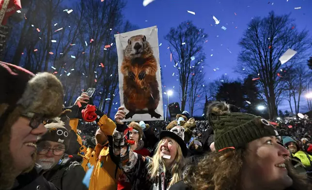 The crowd watches the festivities while waiting for Punxsutawney Phil, the weather prognosticating groundhog, to come out and make his prediction during the 139th celebration of Groundhog Day on Gobbler's Knob in Punxsutawney, Pa., Sunday, Feb. 2, 2025. (AP Photo/Barry Reeger)