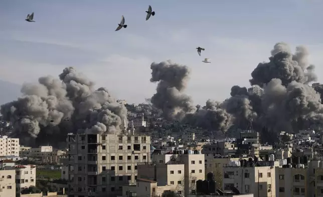 Smoke rises following an explosion detonated by the Israeli army, which said it was destroying buildings used by Palestinian militants in the West Bank Jenin refugee camp, Sunday, Feb. 2, 2025. (AP Photo/Majdi Mohammed)