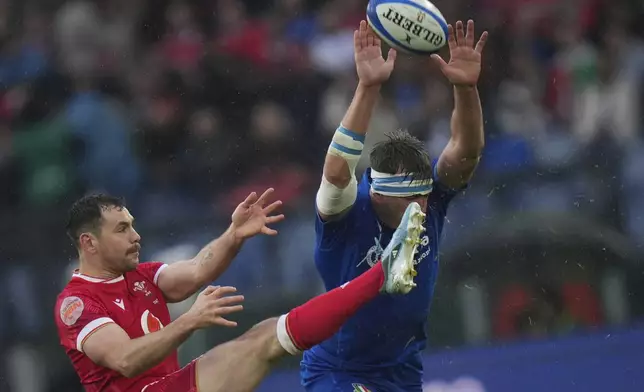 Wale's Tomos Williams, left, has his kick charged down by Italy's Federico Ruzza during the Six Nations rugby union match between Italy and Wales at the Olympic Stadium in Roma, Italy, Saturday, Feb. 8, 2025. (AP Photo/Alessandra Tarantino)