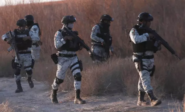 Mexican National Guard members patrol along the Mexico-US border in Ciudad Juarez, Wednesday, Feb. 5, 2025. (AP Photo/Christian Chavez)