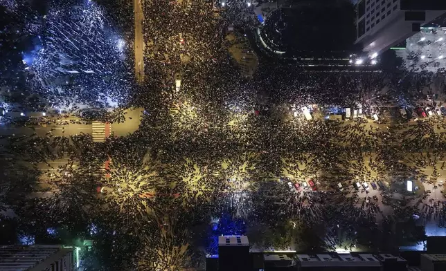 An aerial view of people blocking the Bridge of Freedom during a protest over the collapse of a concrete canopy that killed 15 people more than two months ago, in Novi Sad, Serbia, Saturday, Feb. 1, 2025. (AP Photo/Armin Durgut)