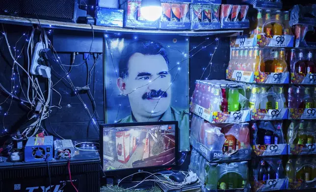 A picture of Abdullah Ocalan, the imprisoned leader of Turkey's banned Kurdistan Workers' Party, or PKK, is displayed inside a shop in the northern Syrian city of Qamishli that is controlled by the US-backed and Kurdish-led Syrian Democratic Forces, Sunday, Jan. 26, 2025. (AP Photo/Bernat Armangue)