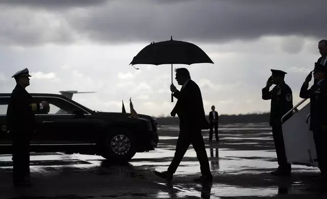 President Donald Trump, center, walks from Air Force Force One after landing at the Naval Air Station Joint Reserve Base in New Orleans, Sunday, Feb. 9, 2025, ahead of the NFL Super Bowl 59 football game between the Philadelphia Eagles and the Kansas City Chiefs. (AP Photo/Ben Curtis)