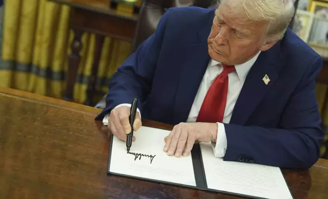 President Donald Trump signs an executive order in the Oval Office of the White House, Monday, Feb. 3, 2025, in Washington. (AP Photo/Evan Vucci)