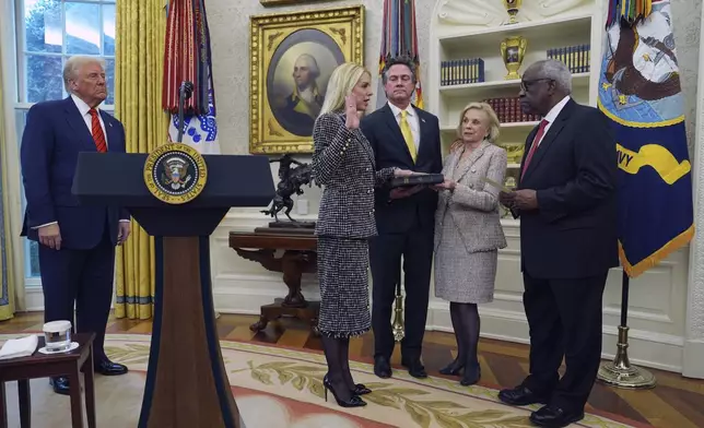 Pam Bondi is sworn in as Attorney General by Supreme Court Associate Justice Clarence Thomas, right, as President Donald Trump, partner John Wakefield and mother Patsy Bondi, look on, in the Oval Office of the White House, Wednesday, Feb. 5, 2025, in Washington. (AP Photo/Evan Vucci)