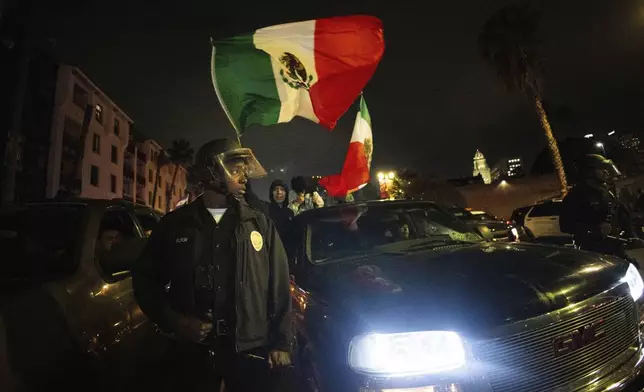Police face off with demonstrators during an immigration rights protest Monday, Feb. 3, 2025, in Los Angeles. (AP Photo/Ethan Swope)