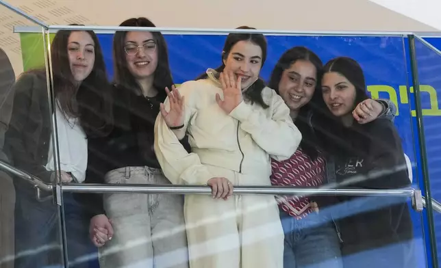 Five former Israeli hostages recently released from Hamas captivity, from right, Daniella Gilboa, Liri Albag, Agam Berger, Karina Ariev and Naama Levy listen to a concert at Beilinson hospital, where they are recovering, in Petah Tikva, Israel, Tuesday, Feb. 4, 2025. (AP Photo/Ohad Zwigenberg)