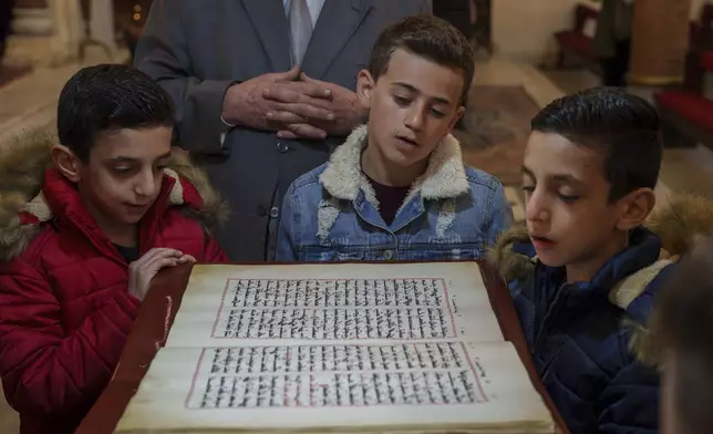 Syriac Orthodox children attend a Mass at the Church of the Virgin Mary in the northeastern Syrian city of Qamishli, which is controlled by the U.S.-backed, Kurdish-led Syrian Democratic Forces, Tuesday, Jan. 28, 2025. (AP Photo/Bernat Armangue)