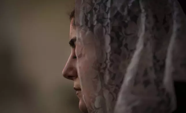 A Syriac Orthodox worshipper attends a Mass at the Church of the Virgin Mary in the northeastern Syrian city of Qamishli, which is controlled by the U.S.-backed, Kurdish-led Syrian Democratic Forces, Tuesday, Jan. 28, 2025. (AP Photo/Bernat Armangue)