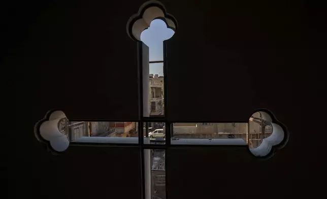 Cars drive past a Syriac Orthodox church in the northeastern Syrian city of Hassakeh, Monday, Jan. 27, 2025. (AP Photo/Bernat Armangue)
