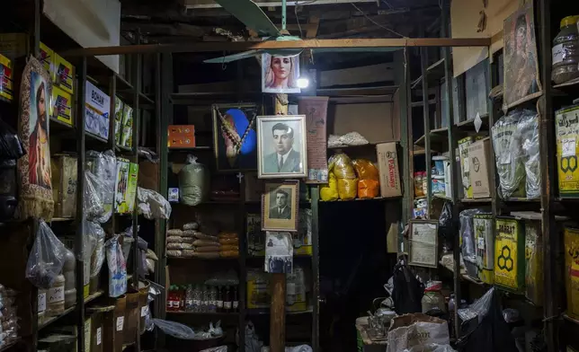 Portraits of the Virgin Mary, Jesus, and a family elder, are displayed inside a Christian-owned shop at a local market in the northeastern Syrian city of Qamishli, Tuesday, Jan. 28, 2025. (AP Photo/Bernat Armangue)