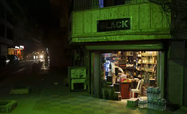 A man works in a liquor store in a Christian residential area of the northeastern Syrian city of Qamishli, which is controlled by the U.S.-backed, Kurdish-led Syrian Democratic Forces, Sunday, Feb. 2, 2025. (AP Photo/Bernat Armangue)