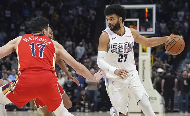 Denver Nuggets guard Jamal Murray, right, drives past New Orleans Pelicans center Karlo Matkovic in the first half of an NBA basketball game Wednesday, Feb. 5, 2025, in Denver. (AP Photo/David Zalubowski)