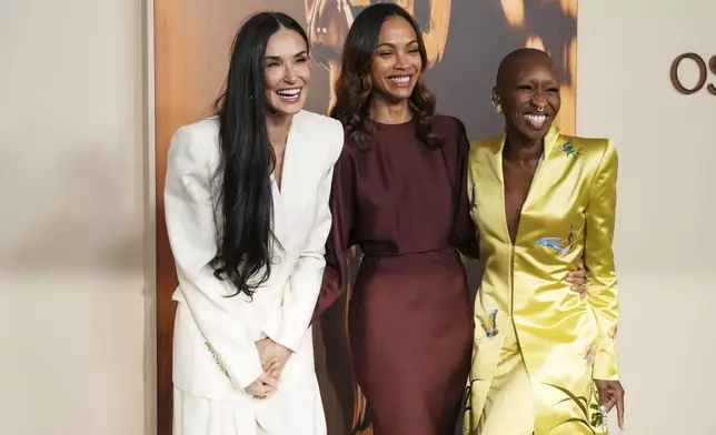Demi Moore, from left, Zoe Saldana, and Cynthia Erivo arrive at the Oscars Nominees Dinner on Tuesday, Feb. 25, 2025, at the Academy Museum of Motion Pictures in Los Angeles. (Photo by Jordan Strauss/Invision/AP)